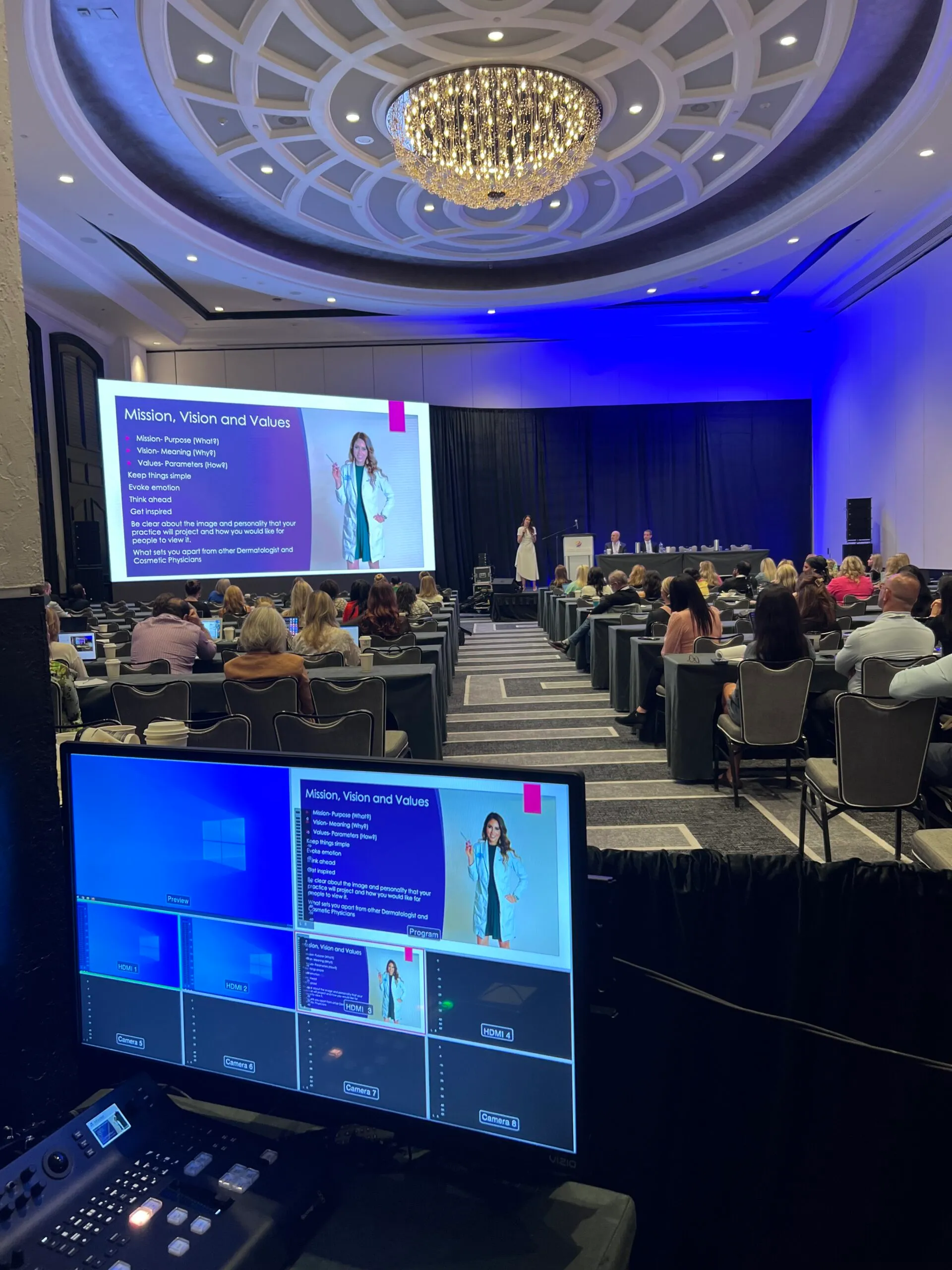 Speaker on stage during a corporate session seen from the control position