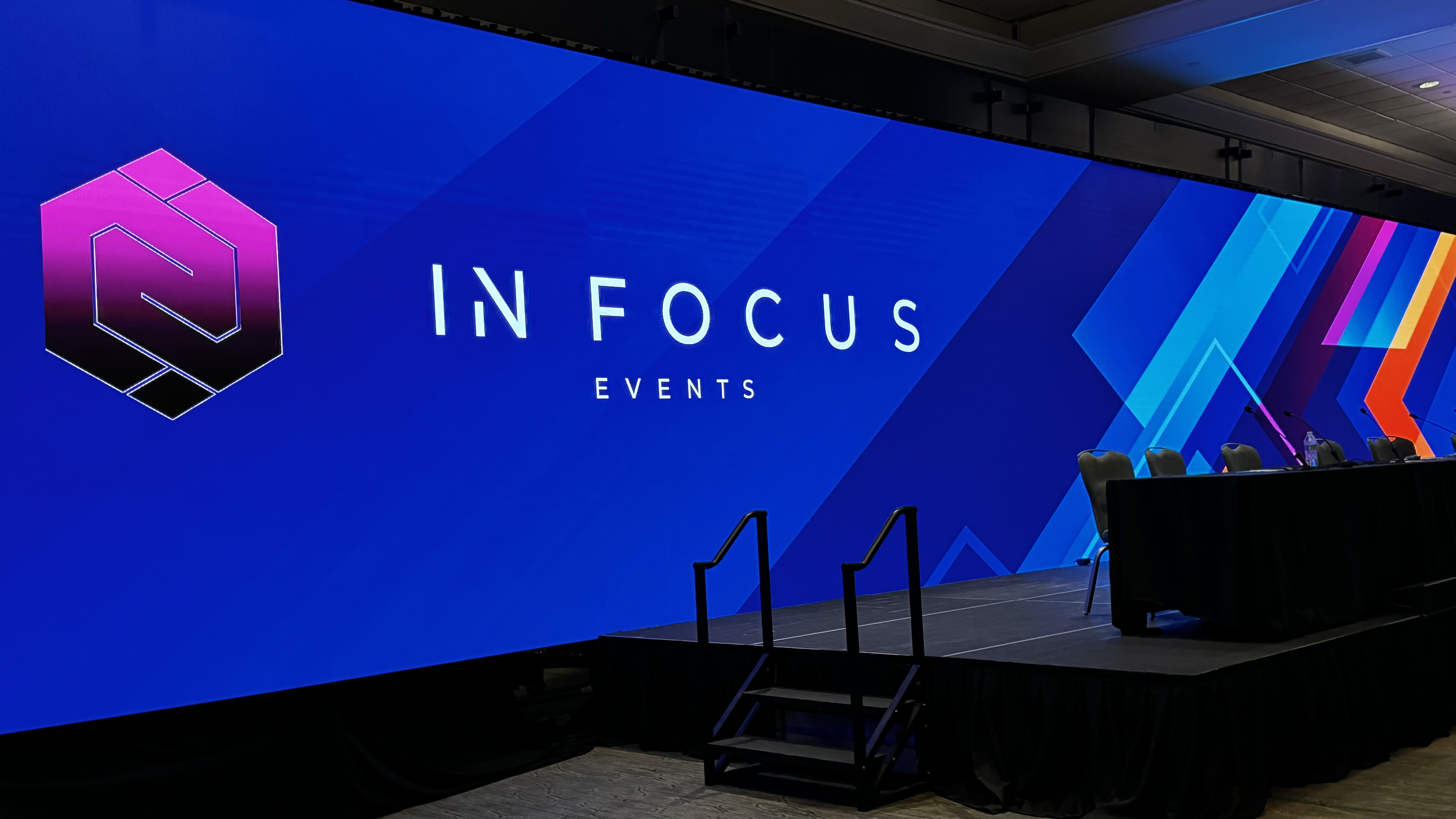 InFocus Events branding displayed across a curved LED wall on stage